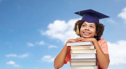 education, school, knowledge and graduation concept - happy smiling african american graduate...