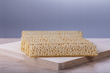 thin bread toasts on a wooden board closeup
