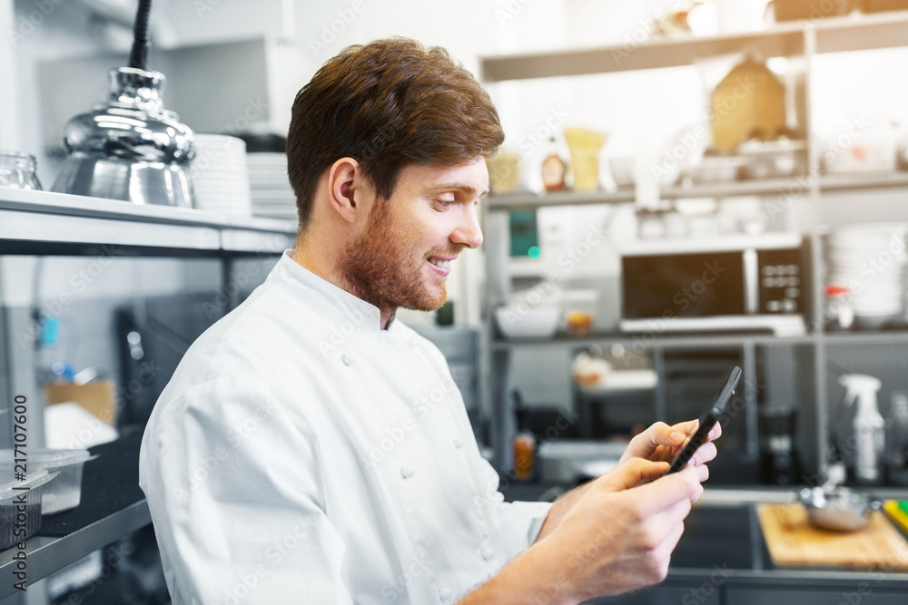 Wall mural cooking, profession and people concept - happy male chef cook with tablet pc computer at restaurant 