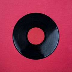Closeup of Vinyl Long Play Record with Label with Copy Space on red background
