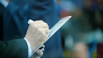 skilled trainer draws hockey game winner strategy in tablet - Powered by Adobe