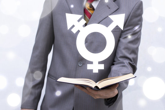 Transgender Learning concept. Young man holds book with transgender (combining gender) symbol icon on a virtual interface.