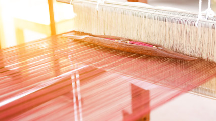 Weaving shuttle on the loom.