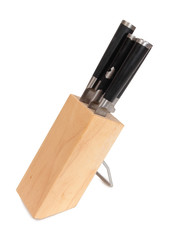 Set of kitchen knives in a wooden stand on a white background