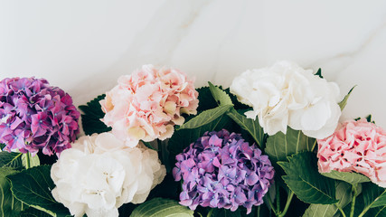 top view of background with colorful hydrangea flowers on marble surface