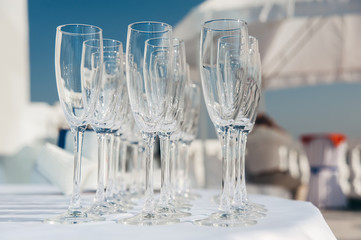 many empty wineglasses in rows at white table. welcome drink. catering