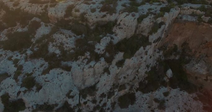 Aerial shot - Tilting down looking at the height of the Cliffs in Zurrieq