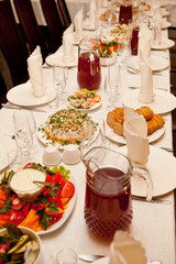 Served for a banquet table with glasses and white napkins and salads, vegetables