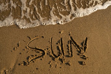 Shot of word sun written on the sand in Turkey