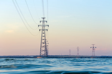 power line standing on the water / technological progress scale is striking