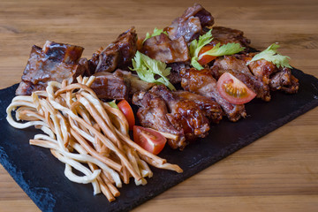 Assorted snacks for beer in the bar. Meat, cheese, onion rings on the grill and deep-fried