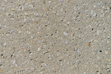 surface of an old concrete wall with splashes of small stones