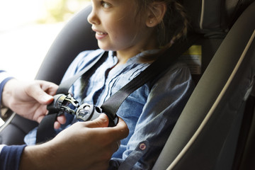 Father helping to put on the seat belt