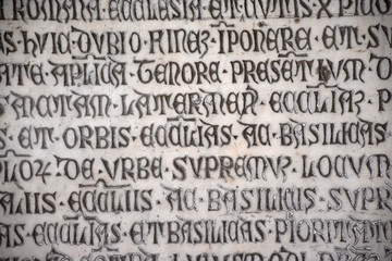Ancient writings in Latin language of religious texts, very common in religious and historical buildings of many Italian cities.