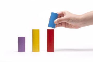 woman hand stack a color wood block isolated white