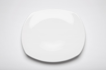 white empty dish with fork on the white background.