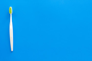 Clean teeth. Toothbrushes on blue background top view copy space