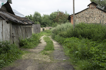 Fototapeta na wymiar Quiet village street with an old barn