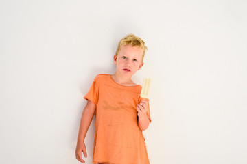 Cute boy eating an ice cream in white background.