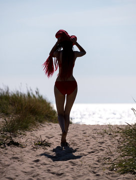 Beautiful  redhead young woman in red swimsuit