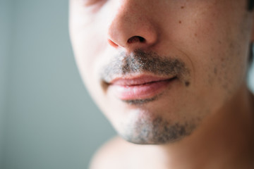A man grows a mustache and beard. Soft focus