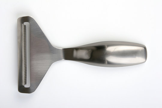 Stinless steel cheese slicer on light background