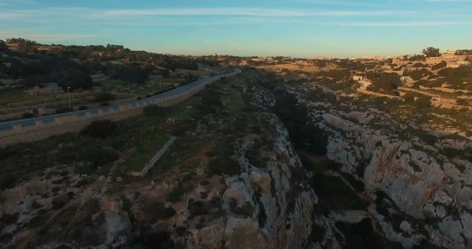 Aerial shot - Flying nearby European Maltese Cliffs during Sunset