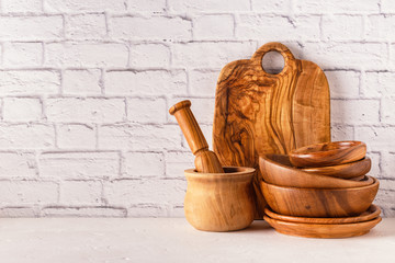 Wooden tableware on a white table.