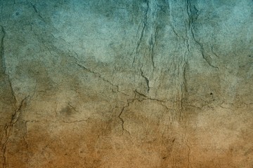 Old hard cracked paper background in dark colors