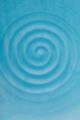 Fototapeta na wymiar Ceramic dish. Blue rippled water waves. Blue background