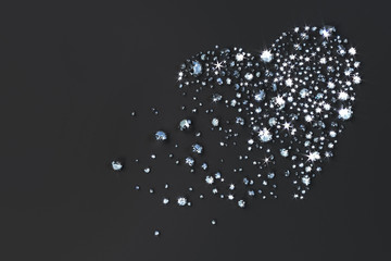 Many diamonds scattered on the table in the shape of a heart. 3d illustration