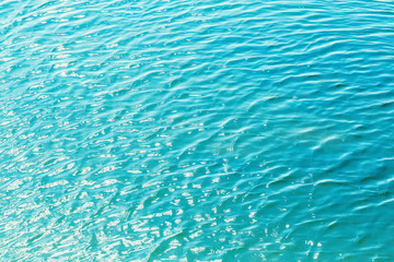 Shining blue wavy water surface ripple background