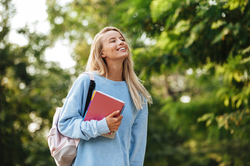 Portrait of a happy young girl student with backpack