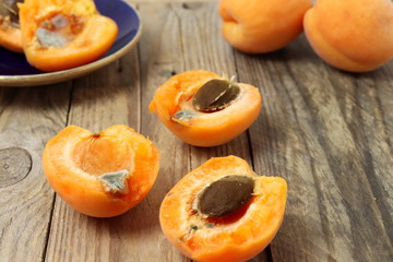 Rotten apricots on wooden table