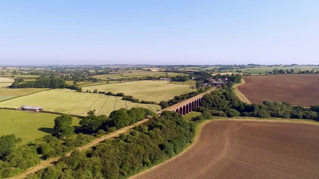 Aerial pan down of a disused railway viaduct in Leicestershire, England.