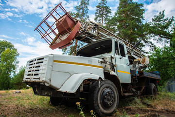 abandoned old truck in a clearing, grunge equipment, disassembled broken