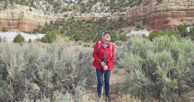 Retired Caucasian woman hiking through dry vegetation in Zion Utah