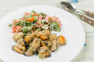 Fried mussels with fresh vegetable salad.