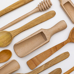 Set of wooden utensils, isolated on white background. View from above