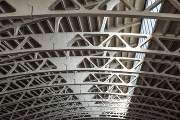 Old arched metal structure. Industrial geometry.