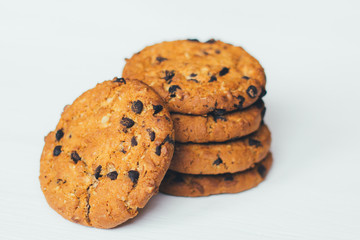 Chocolate cookies stacked on a white background