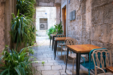 Fototapeta na wymiar Restaurant tables on a street in Split, Croatia