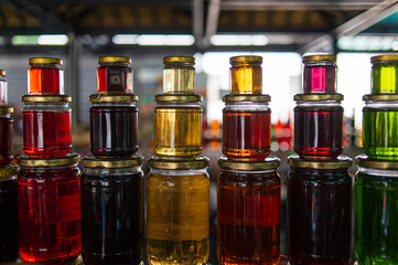 Transparent glass jars with colorful honey