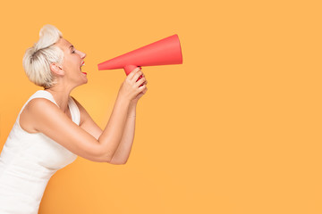 Middle age smiling woman with red megaphone.