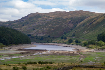 Fototapeta na wymiar Low Water level at Haweswater reservoir reveals the remains of the village of Mardlae Green in summer 2018