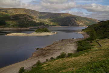 Fototapeta na wymiar Low Water level at Haweswater reservoir reveals the remains of the village of Mardlae Green in summer 2018