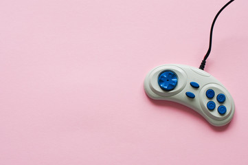 Retro joystick on a coloful paper background. Top view.
