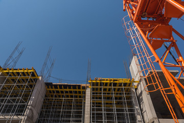 construction crane and a concrete structure of the building on a background the sky. bottom view