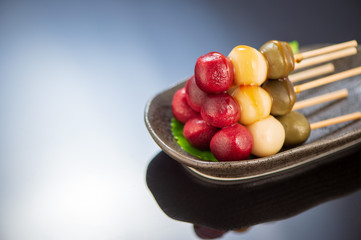 Japanese Dango dessert with 3 different color in pink(red), white, and green, recipe, hanami Dango, tsukimi Dango, copy space.