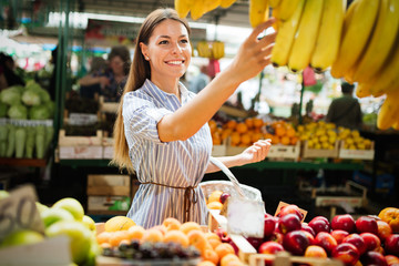 Picture of woman at marketplace buying fruits